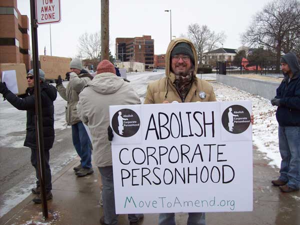 Top Pun with "Abolish Corporate Personhood" sign in front of federal courhouse in Toledo, Ohio, at Move To Amend protest sponsored by Occupy Toledo
